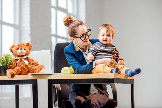 istock Multitasking businesswoman with her son working at the office 898586024
