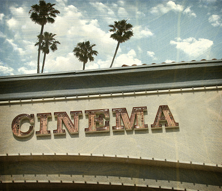 aged and worn neon cinema sign