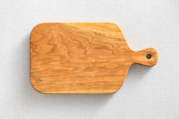 istock Cherry handmade wood cutting board on the linen 898586950