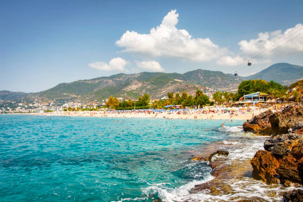 landscape of resort sea beach in lagoon bay on summer sunny day. rocky beach and mountains on horizon in tropical sea town. beautiful paradise nature of turkey perfect for relax. - lagoon nebula imagens e fotografias de stock