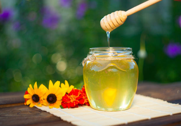 istock Delicious delicious honey in  jar on table 898589716