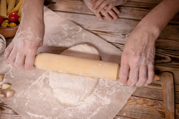 istock Female hands cook dough for home-made pizza. 898592940
