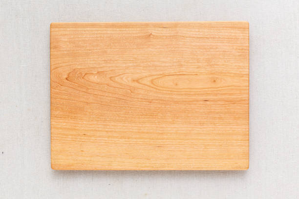 istock Cherry handmade wood cutting board on the linen 898593716