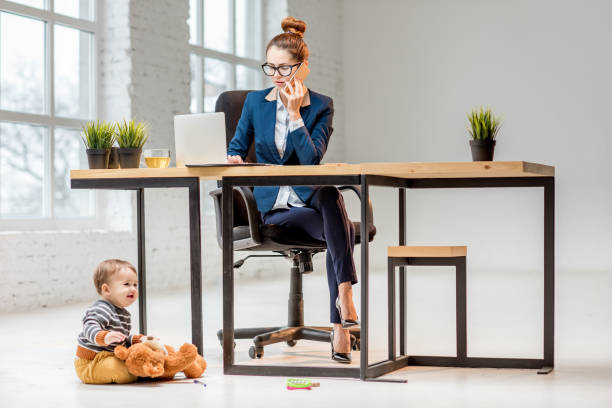 istock Multitasking businesswoman with her son at the office 898596300