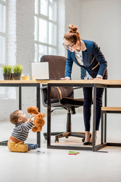 istock Multitasking businesswoman with her son at the office 898596352