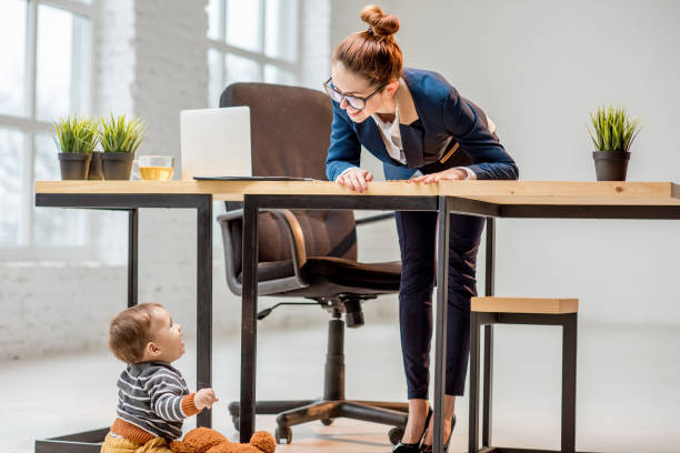 istock Multitasking businesswoman with her son at the office 898596364