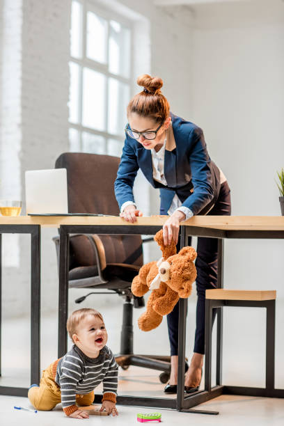 istock Multitasking businesswoman with her son at the office 898596398