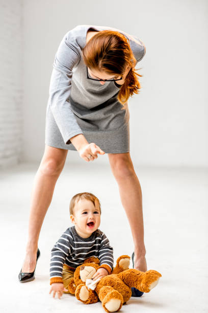 istock Baby boy near mother's legs 898597832