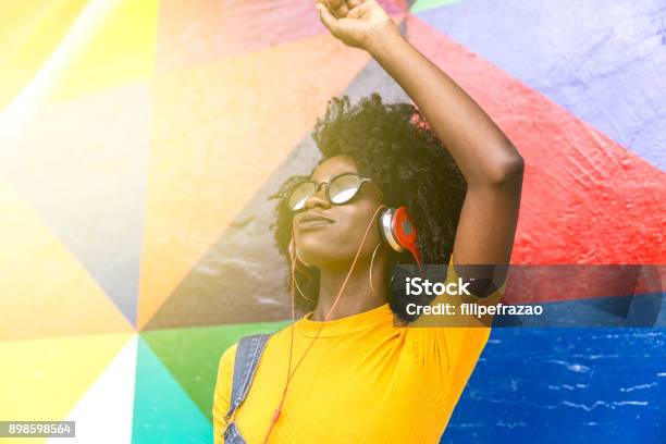 African Woman Dancing To Her Favorite Song Stock Photo - Download Image Now - Reggae, Music, Dancing