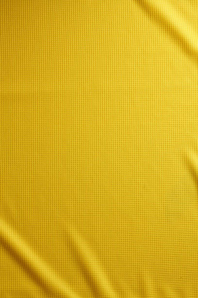 vêtements de sport tissu texture fond. vue de dessus surface textile tissu. maillot de foot jaune. espace de texte - sport fan football soccer photos et images de collection