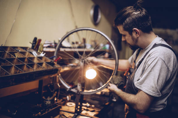 istock Young hipster man repairing bicycle wheel 898604898