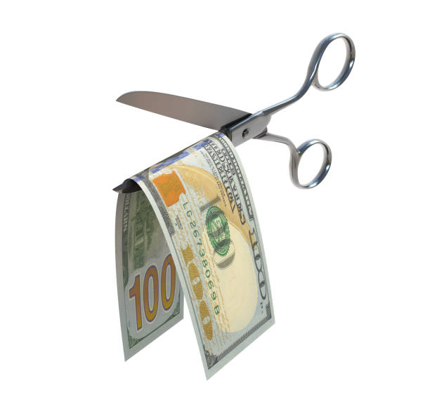 istock Hundred dollar bill being cut in half with scissors 898609178