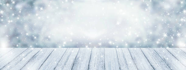 istock Christmas background with wooden table and snowfall 898612010