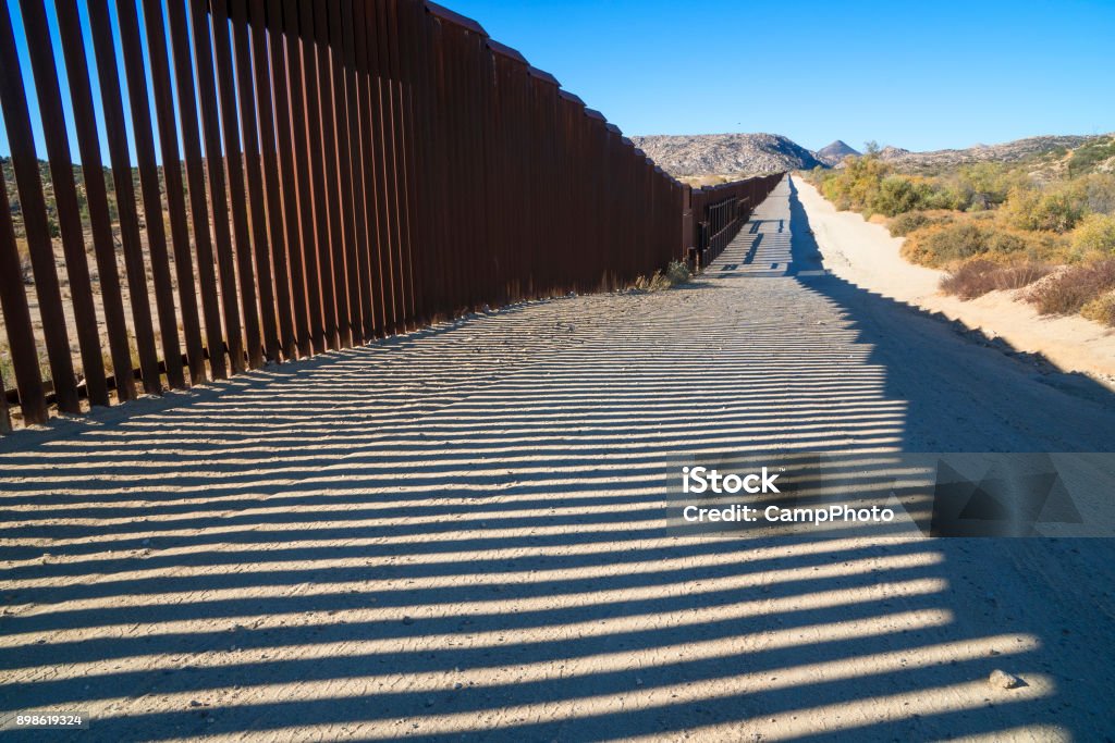 Fence at Jacumba Mid day on US-Mexico border. Jacumba Springs, California. Baja California Norte Stock Photo