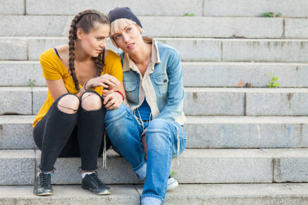 istock Two young women sitting on stairs 898624478