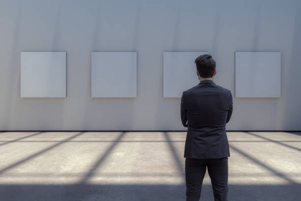 Man watching blank picture frame at art gallery