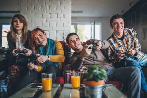 istock Group of friends playing digital games at home. 898628514