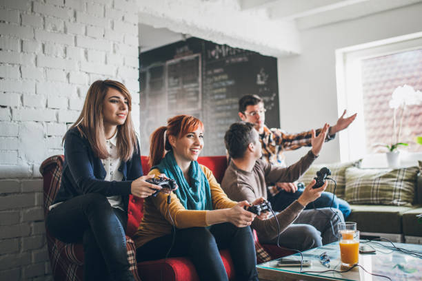 istock Group of friends playing digital games at home. 898628708
