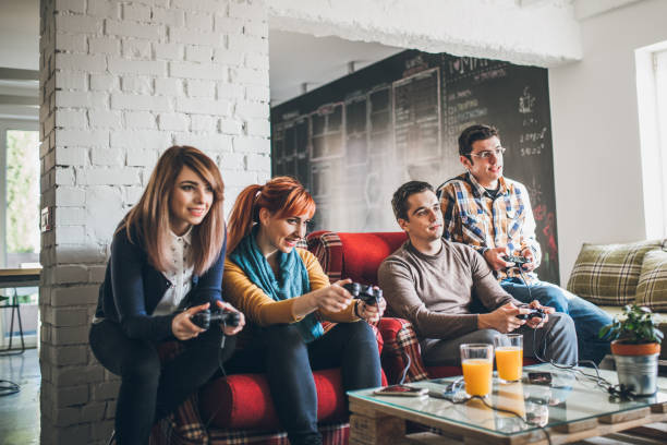 istock Group of friends playing digital games at home. 898628716