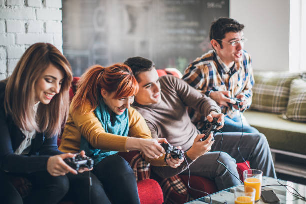 istock Group of friends playing digital games at home. 898628718