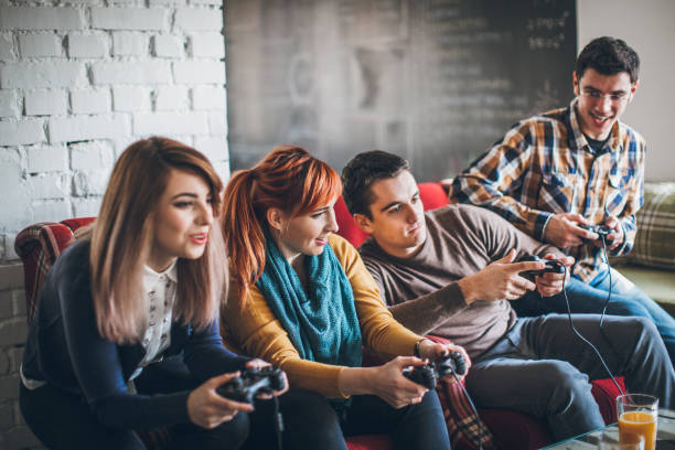 istock Group of friends playing digital games at home. 898628728