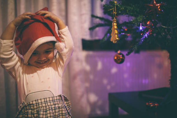 istock Cute little girl decorating Christmas Tree 898641286