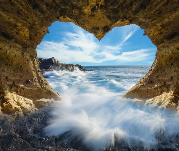 Photo of view of the ocean from a heart-shaped cave