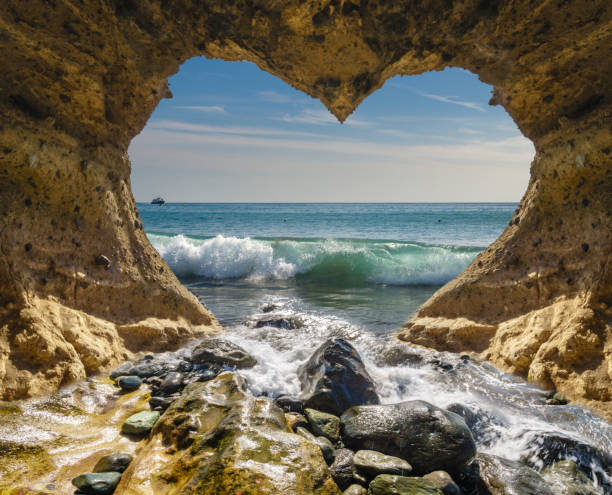 istock view of the ocean from a heart-shaped cave 898641474