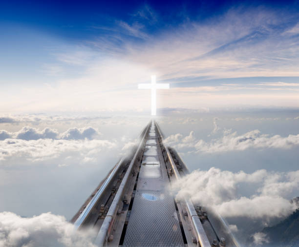 railway tracks leading among the clouds to the glowing cross railway tracks leading among the clouds to the glowing cross following jesus stock pictures, royalty-free photos & images