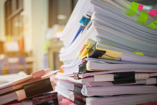 istock Paper stack, Pile of unfinished documents on office desk related to business functions. Stack of business papers for Annual Report files, Document is written,drawn,presented. Business offices concept. 898643892