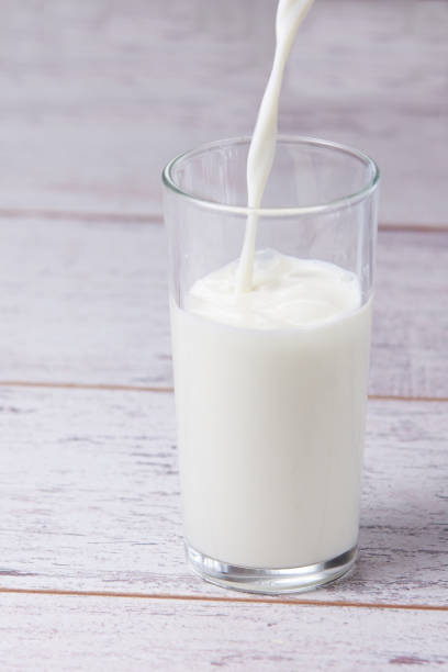 istock Fill glass milk. White drink. Light background 898651998