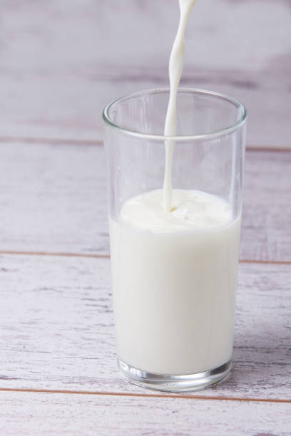 istock Fill glass milk. White drink. Light background 898652008