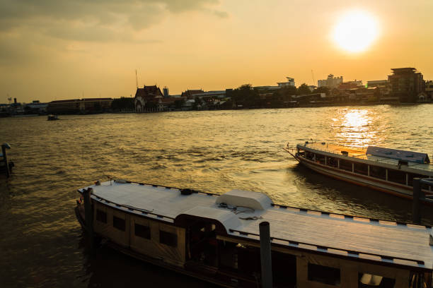 Tha Maharaj boat pier in the evening on Chao Phaya river nearby the Grand Palace Tha Maharaj boat pier in the evening on Chao Phaya river nearby the Grand Palace tha maharaj pier stock pictures, royalty-free photos & images