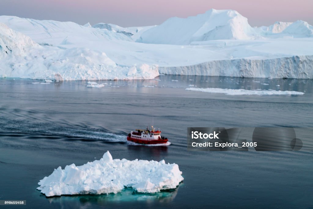 Arctic Icebergs on Arctic Ocean in Greenland Arctic Icebergs Greenland in the arctic sea. You can easily see that iceberg is over the water surface, and below the water surface. Sometimes unbelievable that 90% of an iceberg is under water Greenland Stock Photo