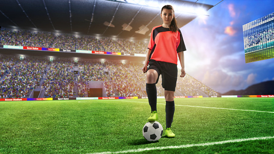 female football player in red uniform on soccer stadium