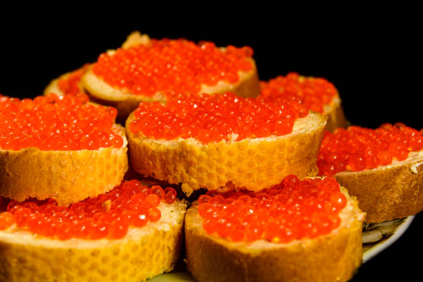 istock Sandwiches with the red caviar isolated on black background 898664866
