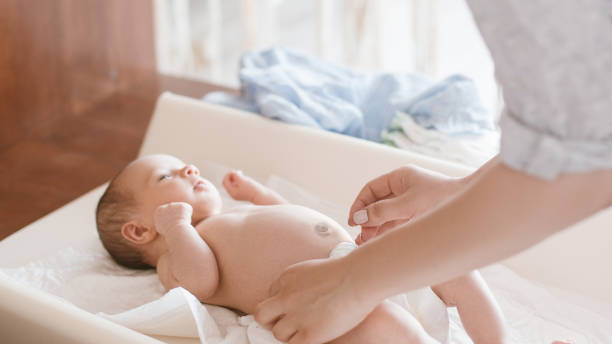 istock mother changes diapers to her newborn baby 898666066