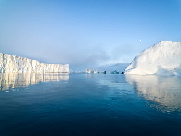 Arctic Icebergs on Arctic Ocean in Greenland Arctic Icebergs Greenland in the arctic sea. You can easily see that iceberg is over the water surface, and below the water surface. Sometimes unbelievable that 90% of an iceberg is under water arctic ocean photos stock pictures, royalty-free photos & images
