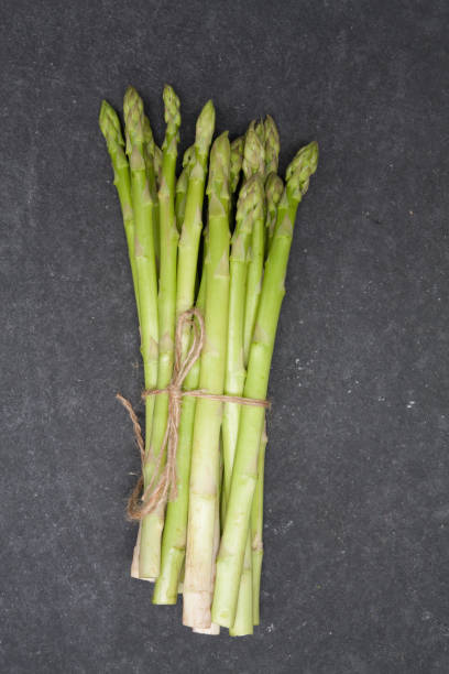 istock bunch of asparagus over slate background 898667156