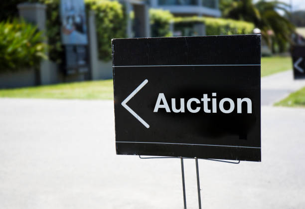 Auction sign Auction sign, outside suburban home, positioned on front lawn. auction photos stock pictures, royalty-free photos & images