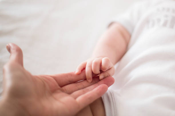istock Baby reaching out for parent's hand 898670384