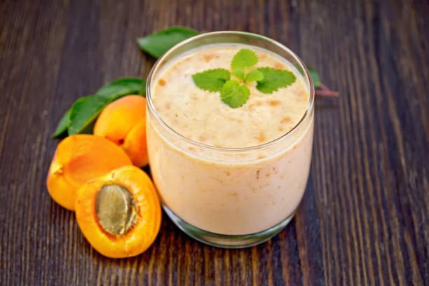 istock Milkshake apricot in glassful on board 898670454