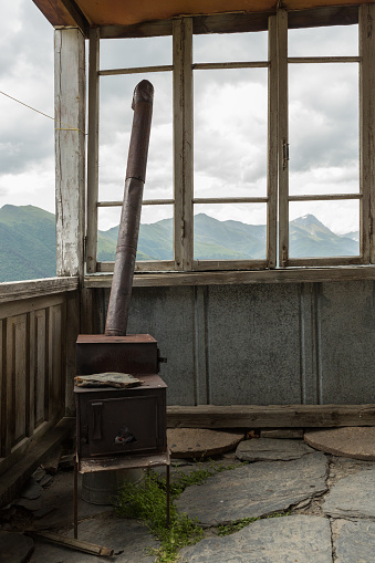 glassless window on a rustic porch of a house in the remote mountain village of Bochorna in the Tusheti region of Georgia