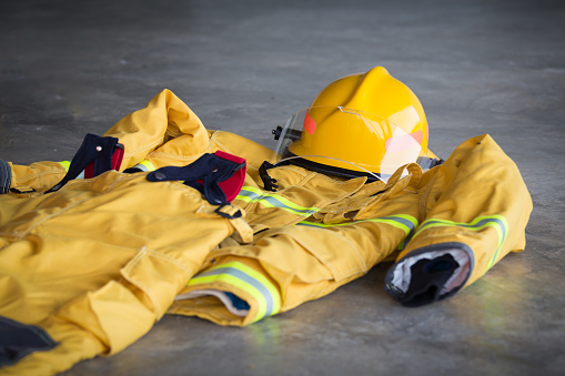 bombero protección traje y casco espera en tierra en estación de bomberos photo