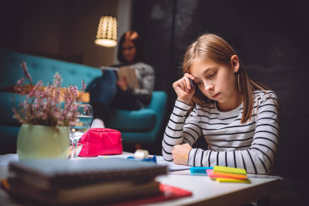 istock Girl doing homework late at night 898680232