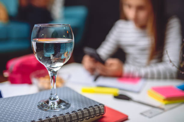 istock Glass of water on notebook 898680298