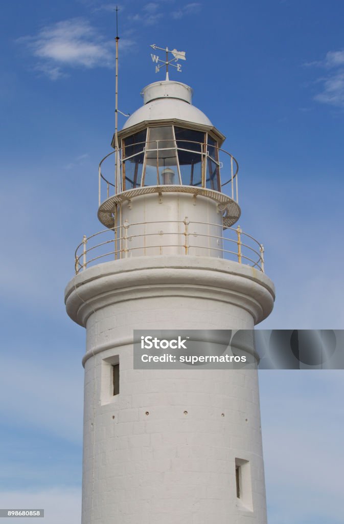 Lighthouse in the background of the sky in the town of Paphos Lighthouse in the background of the sky in the town of Paphos, Cyprus Beacon Stock Photo