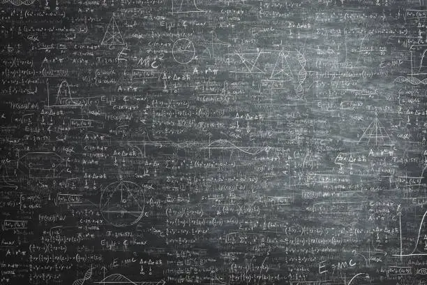 Photo of dirty grunge chalkboard full of mathematical problems and formula