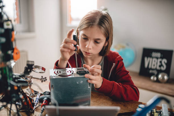 istock Girl modifying power supply and  learning robotics 898684168
