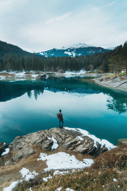istock Man walking near Cauma lake in Switzerland 898686452
